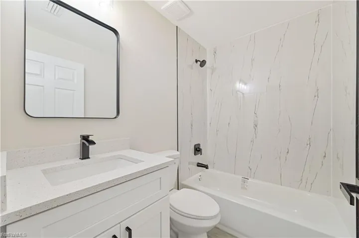 Full bath featuring vanity and shower / bath combination