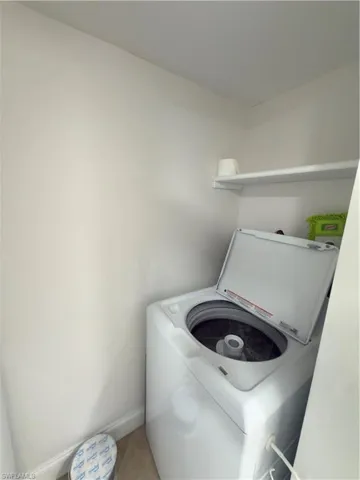 Laundry room featuring washer / dryer and light tile patterned flooring