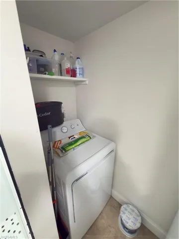 Laundry area featuring washer / clothes dryer and tile patterned flooring