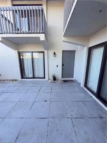 Entrance to property featuring stucco siding and a patio