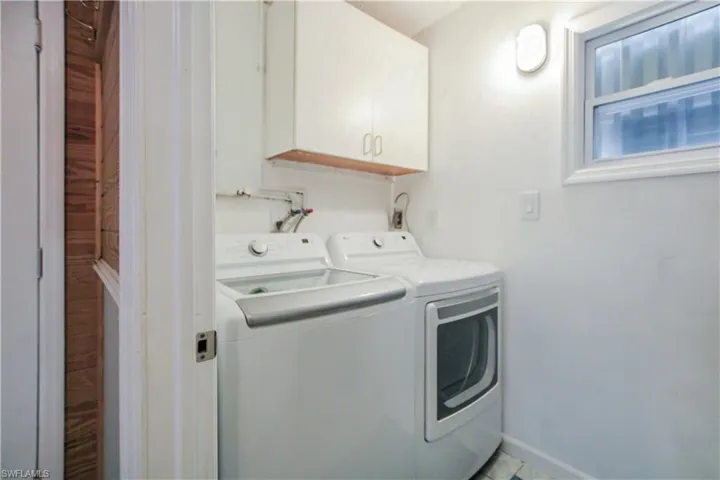 Laundry room featuring washer and dryer and cabinets