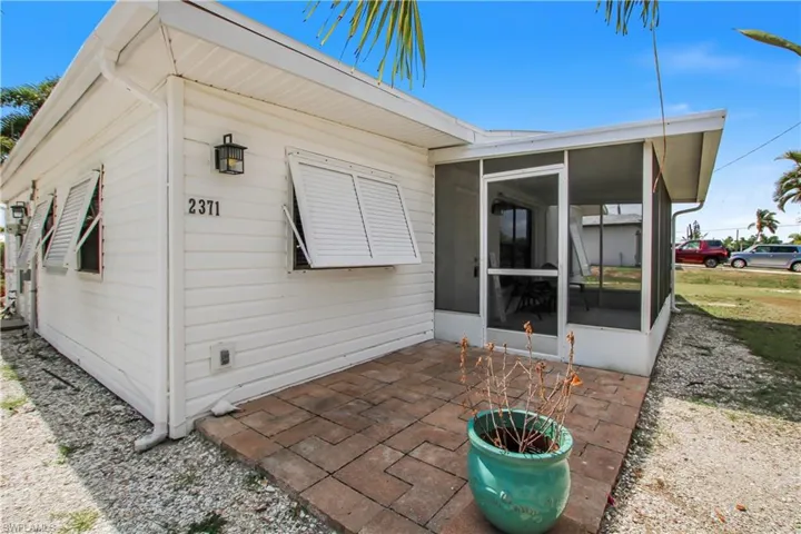 View of patio featuring a screened porch