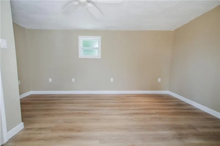 Bedroom featuring wood-type flooring and ceiling fan