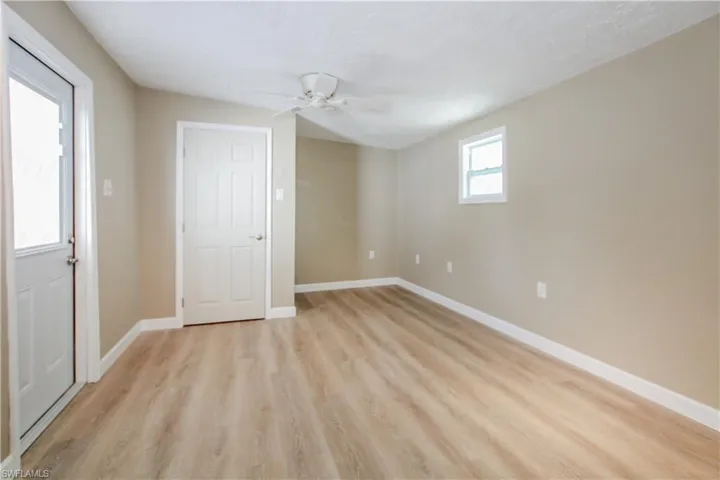 Unfurnished bedroom with ceiling fan and light hardwood / wood-style floors