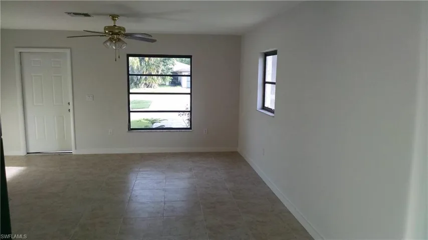 Unfurnished room featuring a ceiling fan and light tile patterned flooring