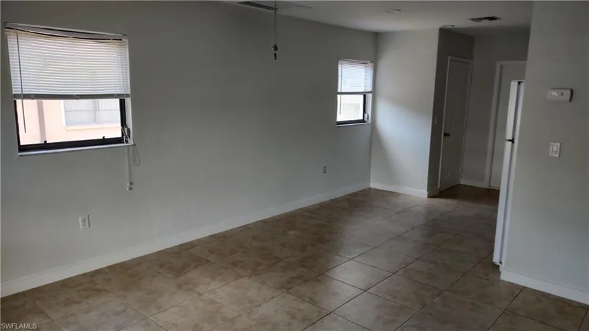 Spare room with light tile patterned flooring