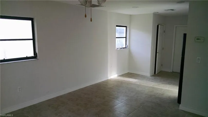 Spare room featuring baseboards and ceiling fan