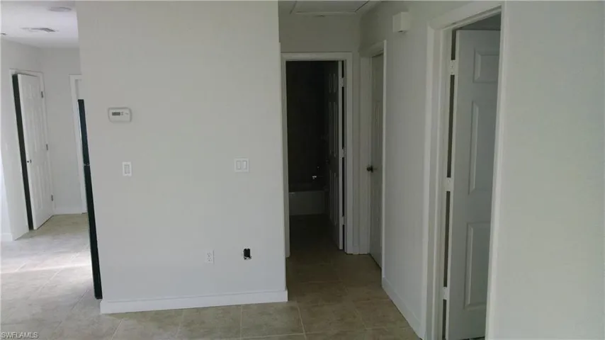 Unfurnished bedroom featuring light tile patterned floors and a closet