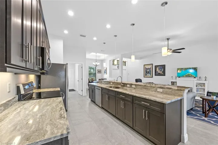 This kitchen is perfect for entertaining! It offers plenty of space for cooking and sitting at the oversized island. The open floor plan allows all parties to be involved, whether they're cooking, eating, or just hanging out.