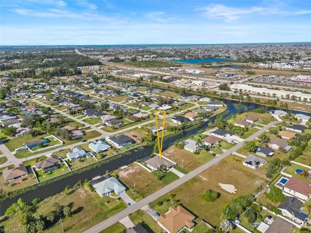 This photo shows an aerial view of the home. The home is located on a freshwater canal.