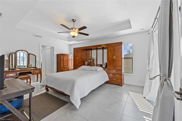 This is the primary bedroom. It is full of light, thanks to the sliders that open to a screened lanai.
