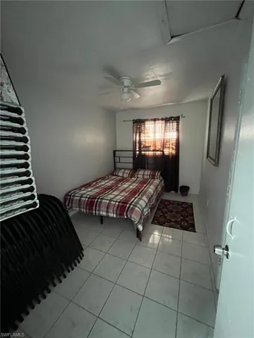 Tiled bedroom with ceiling fan