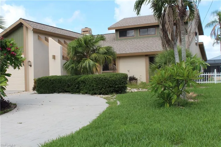 View of front of home featuring a garage and a front lawn
