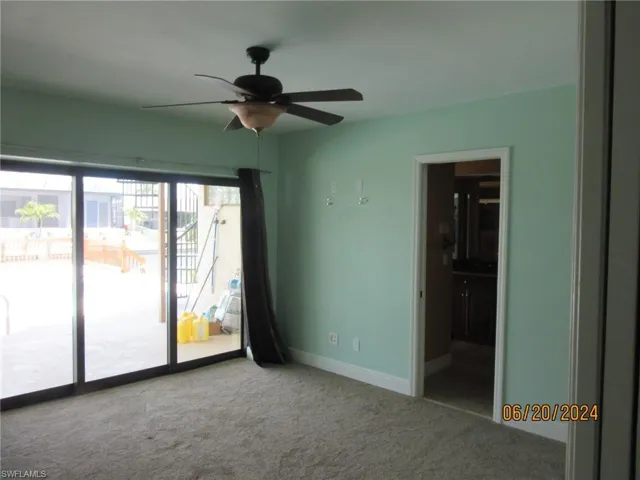 Spare room with carpet flooring and ceiling fan