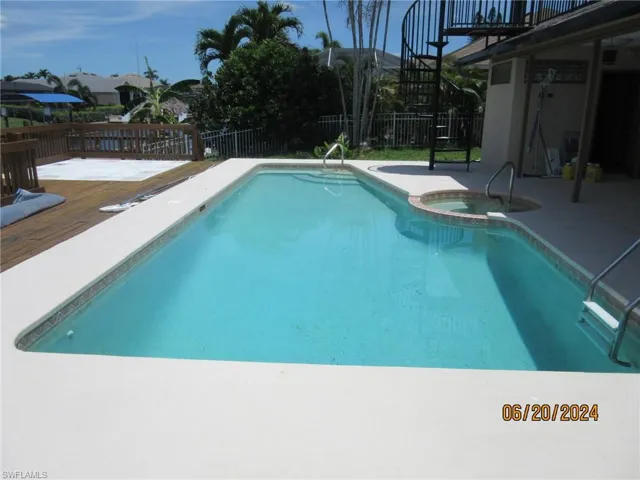 View of pool featuring a deck and an in ground hot tub