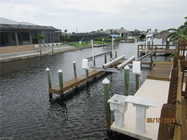 View of dock with a water view and a lanai