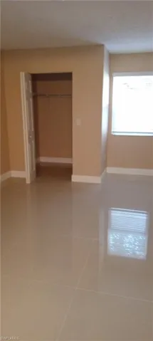 Unfurnished bedroom with tile patterned floors and a closet
