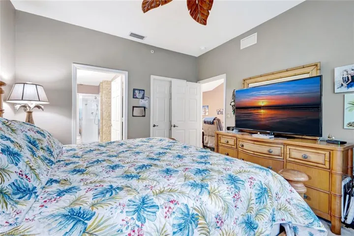 Bedroom with ceiling fan and ensuite bath