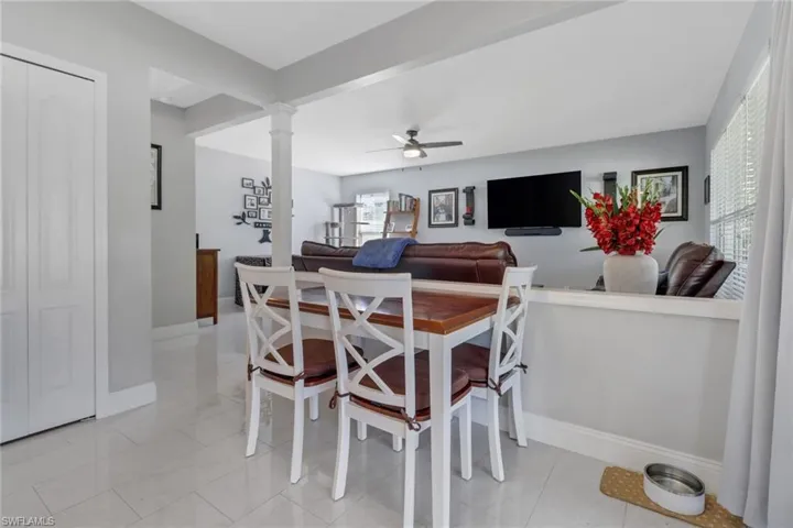Dining area featuring light tile patterned floors, and decorative columns