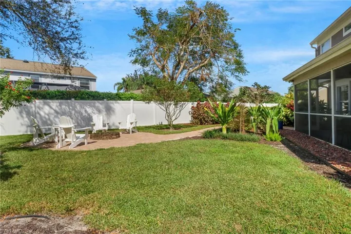 View of yard featuring an outdoor fire pit, a patio area, and a sunroom