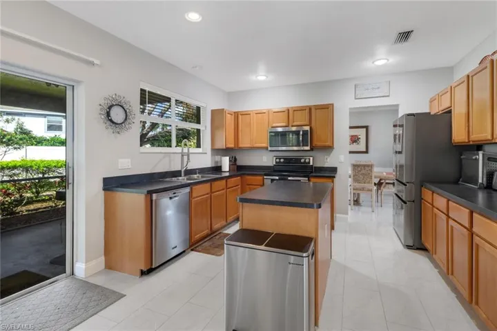Kitchen featuring sink, a center island, stainless steel appliances, and plenty of natural light