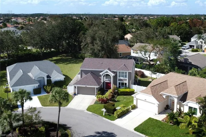 Drone/aerial view front of home shows large fenced backyard