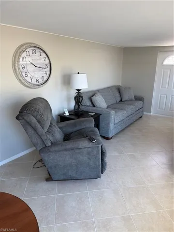 The room features light-colored walls and square floor tiles