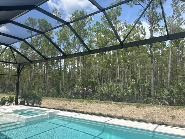 View of pool featuring glass enclosure