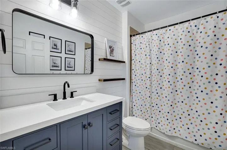 Bathroom featuring vanity, a shower with shower curtain, and wood finished floors