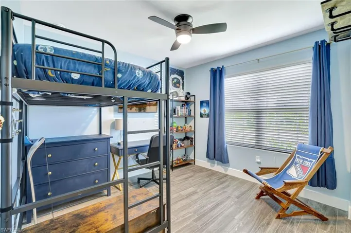 Bedroom with wood finished floors and a ceiling fan