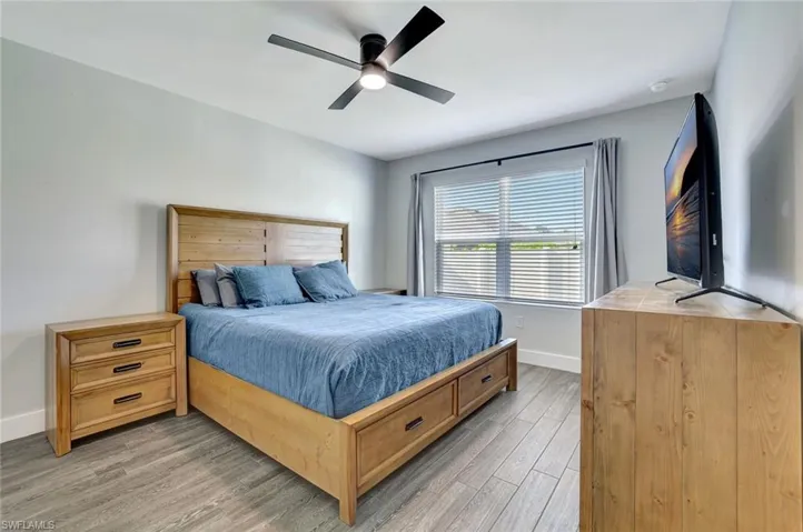 Bedroom with light wood finished floors and a ceiling fan