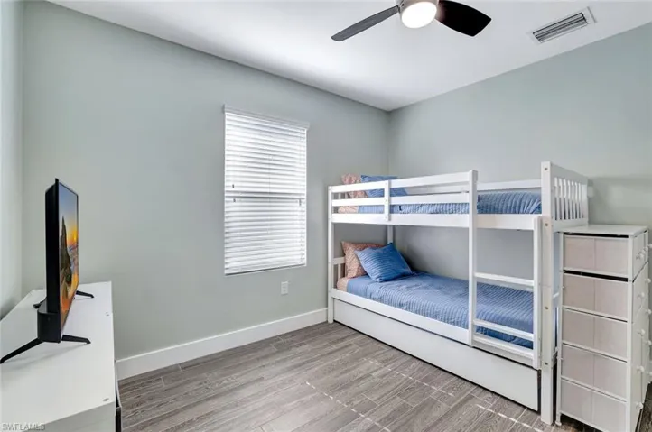 Bedroom with wood finished floors and a ceiling fan