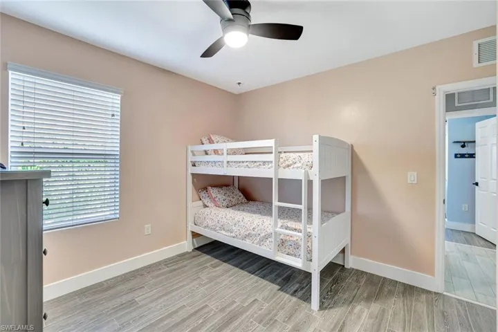 Bedroom with wood finished floors and ceiling fan