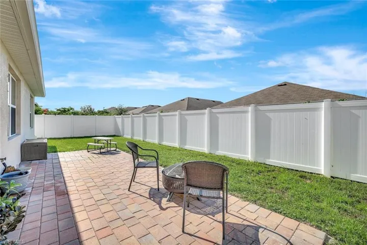 Fenced backyard with a patio area