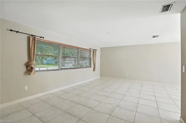Empty room featuring light tile patterned floors