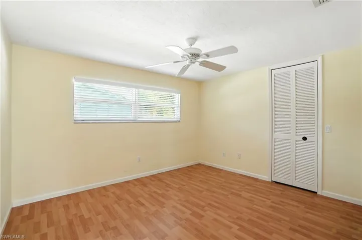 Unfurnished bedroom featuring light wood-type flooring, a closet, ceiling fan, and a textured ceiling