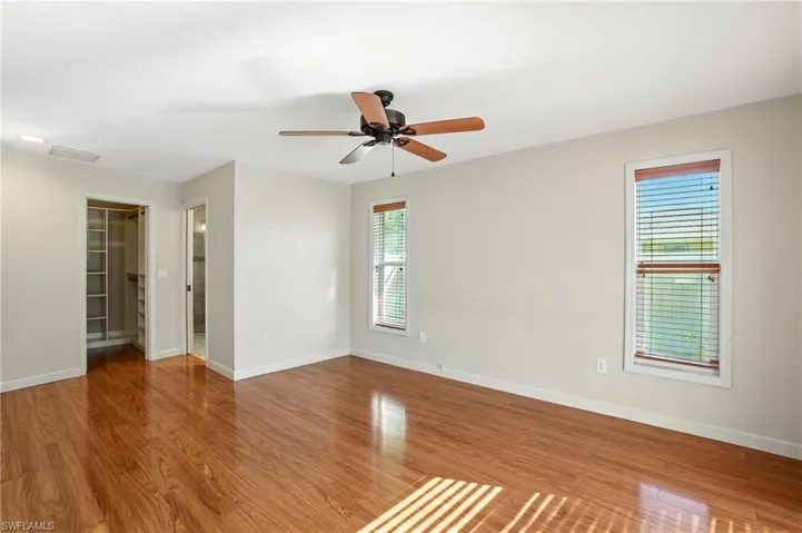 Unfurnished room featuring wood finished floors and a ceiling fan