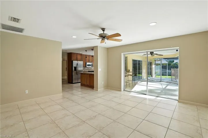 Unfurnished room with recessed lighting, a ceiling fan, light tile patterned floors, and a sunroom