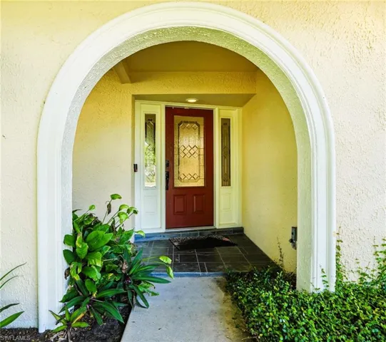 Property entrance featuring stucco siding