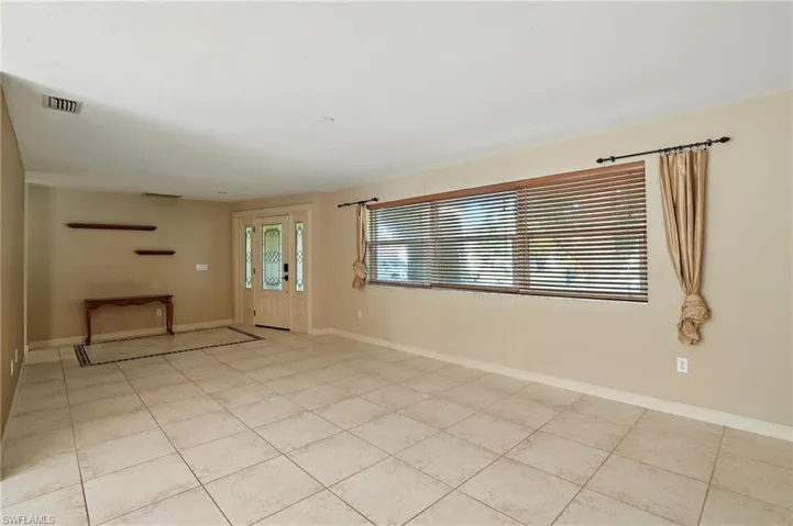 Unfurnished room with baseboards and light tile patterned floors