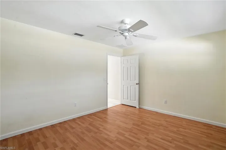 Empty room featuring light wood-style floors and ceiling fan