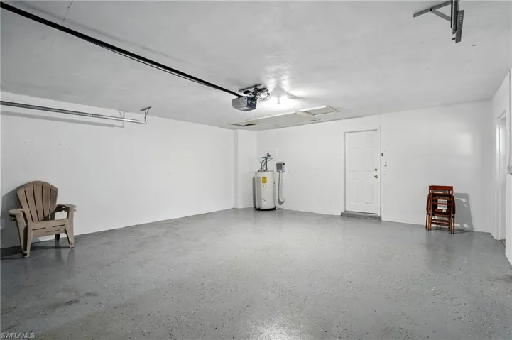 Garage with electric water heater and a garage door opener