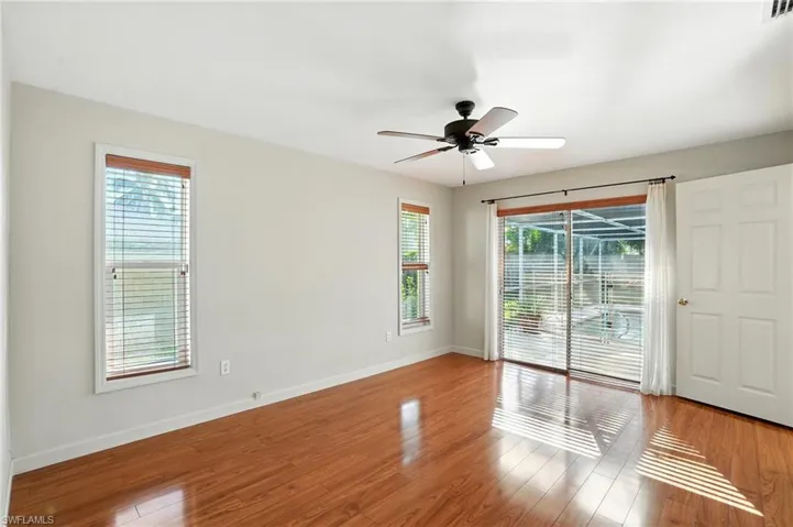 Spare room with healthy amount of natural light, wood finished floors, and ceiling fan