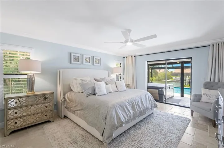 Primary bedroom featuring access to lanai and crown molding