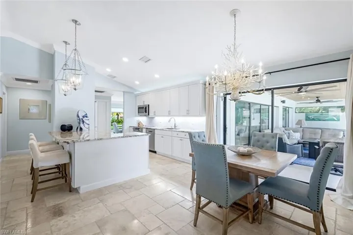 Kitchen with 42" wood white cabinets, plenty of natural light, and breakfast bar. Extra storage underneath breakfast bar.