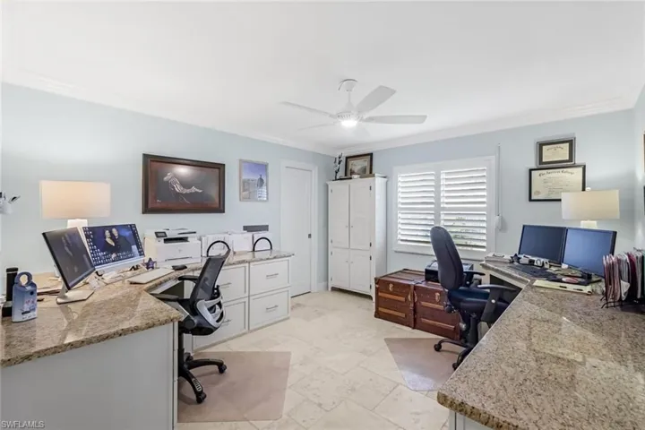 3rd bedroom currently utilized as a home office. Cabinetry is built on top of the stone floors to easily converty into a bedroom. Walk in closet.