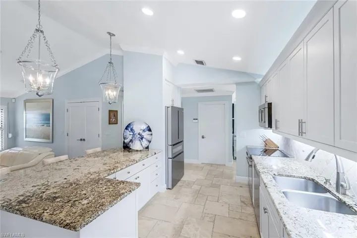 Bright & open kitchen with Bosch appliances and level 3 granite countertops. Bosch package includes an induction stove and a refrigerator with a 15 bottle wine drawer.