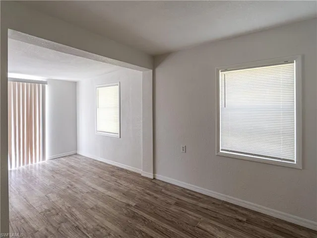 Spare room with a textured ceiling and wood-type flooring