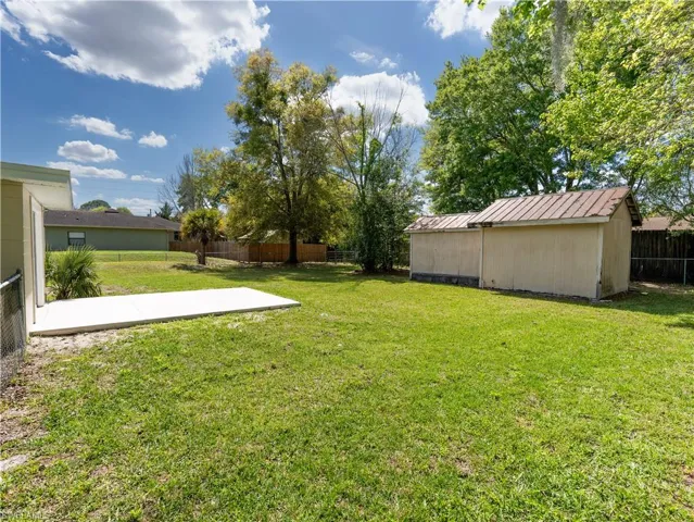 View of yard with an outdoor structure and a patio area
