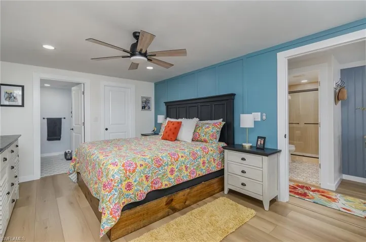 Bedroom featuring light wood-type flooring, recessed lighting, ensuite bathroom, and a ceiling fan